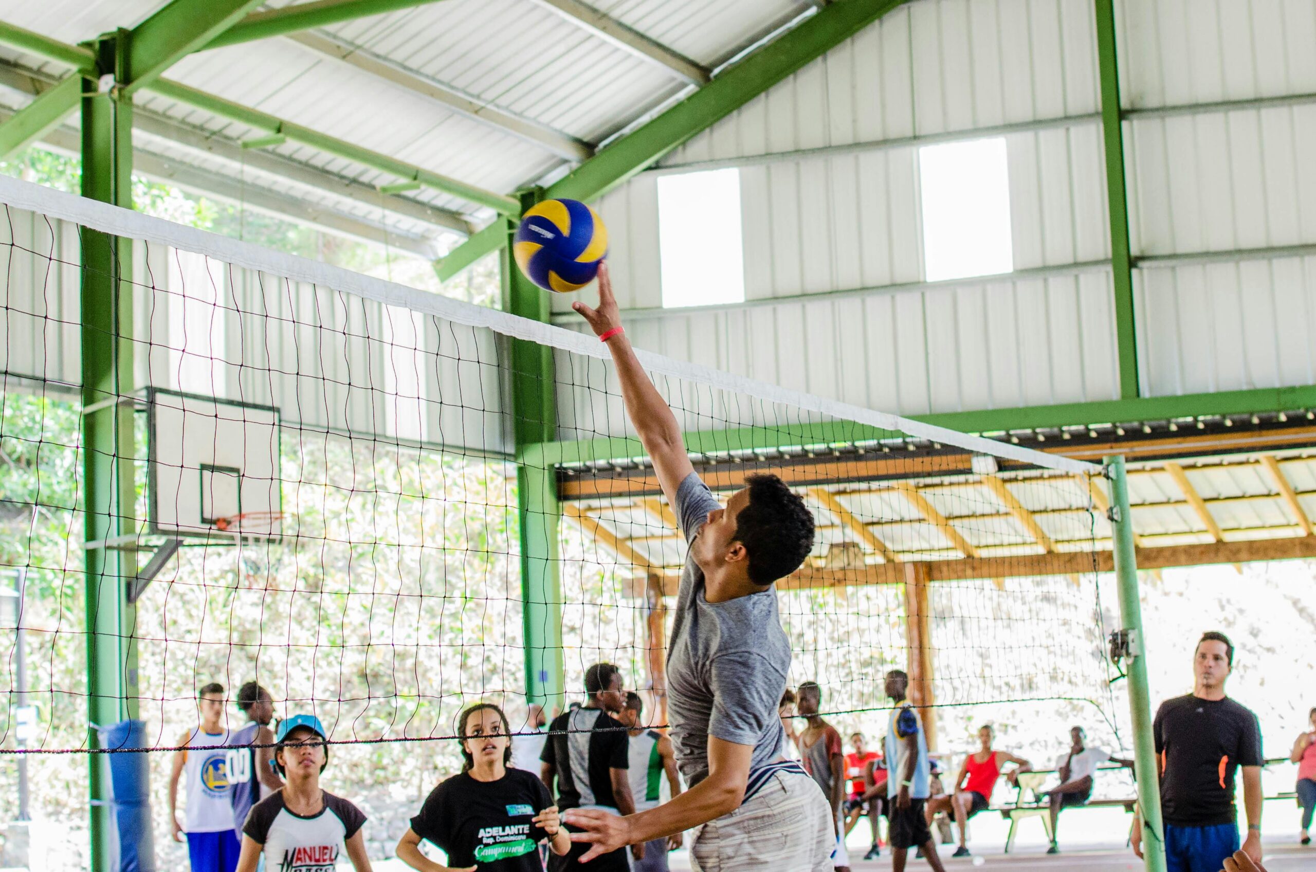 Dynamic action shot of players engaged in a competitive indoor volleyball game.